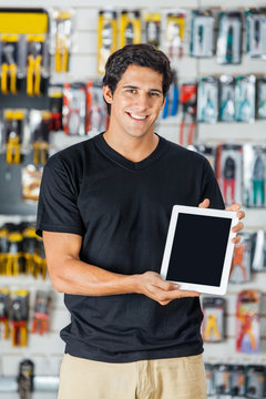 Smiling Man Presenting Digital Tablet In Hardware Store