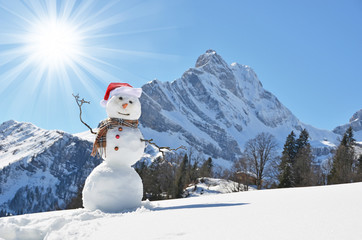 Snowman against Alpine panorama