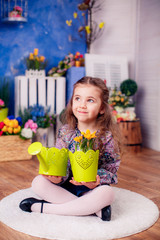 Obraz premium happy little girl. watering the flowers in the pot. Mother's Day