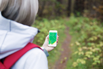 Woman using navigation app on smartphone