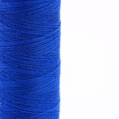 Close-up view of a spool of blue thread