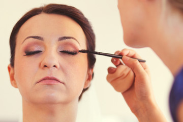 Make up artist preparing the bride for her wedding day