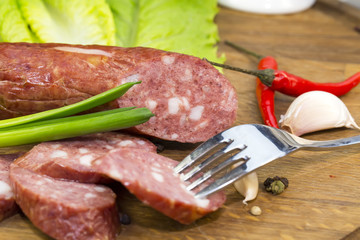 sausages on a wooden plate with vegetables in a restaurant