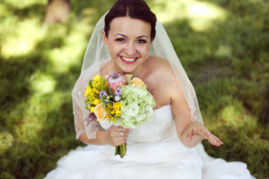 beautiful bride in park with flowers