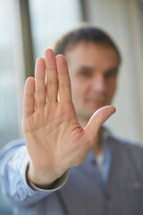 Obraz premium man in shirt showing his palm, closeup