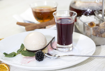 creamy dessert is decorated with blackberries