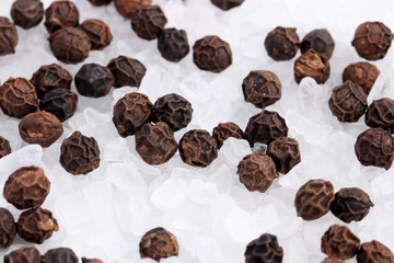 Extreme close-up of coarse salt and black peppercorns