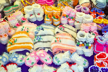 Fototapeta na wymiar Knitted woolen baby shoes and hats