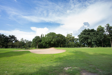 golf course with sand bunker and green grass