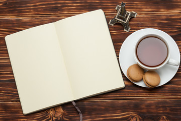 Obraz na płótnie Canvas Open Notepad. Cup Of Tea. Macaroon Cookies. Wooden Background