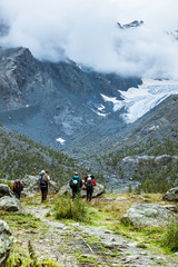 Fototapeta na wymiar A group of mountaneers hiking in Italy, Valmalenco