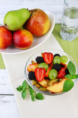 Fototapeta na wymiar fresh tasty fruit salad on wooden table