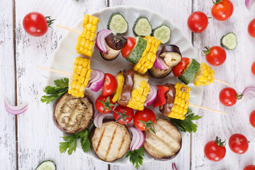 Sliced vegetables on picks on plate on table close-up