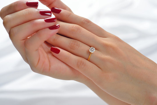 Wedding Ring On Hand Of Bride On White Cloth