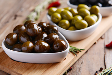 Different marinated olives on table close-up