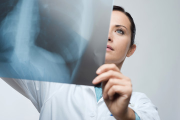 Female doctor examining x-ray image