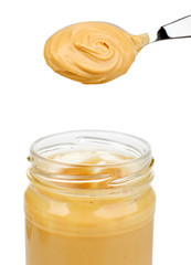 Creamy peanut butter in jar, isolated on white