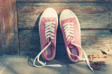 Sneakers on floor on wooden background