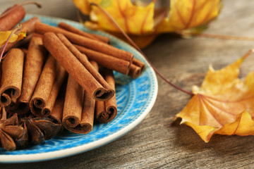Cinnamon sticks and stars anise with yellow leaves