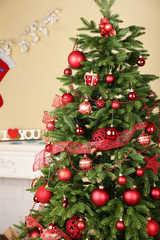 Fototapeta na wymiar Decorated Christmas tree in room closeup