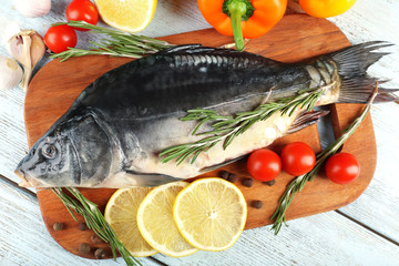 Fresh raw fish and food ingredients on table