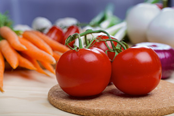 Tomatos with vegetables on a background