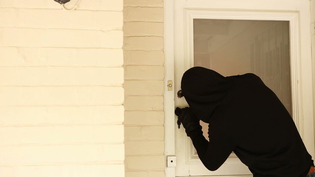 Burglar breaking open the door