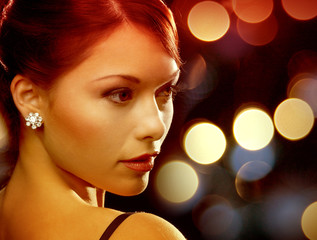 woman in evening dress wearing diamond earrings