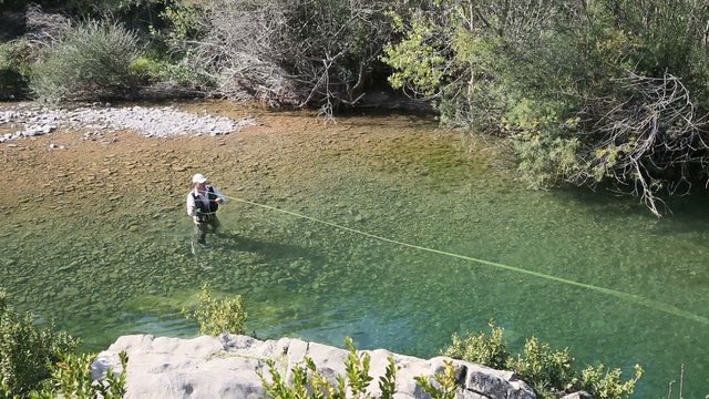Upper view of fly fisherman in river