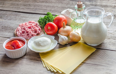 Ingredients for lasagne on the wooden background