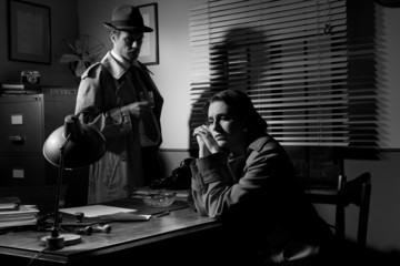 Detective interviewing a young pensive woman in his office