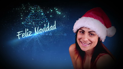 Festive brunette blowing a magical christmas greeting - Powered by Adobe