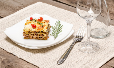 Portion of lasagna on the wooden table