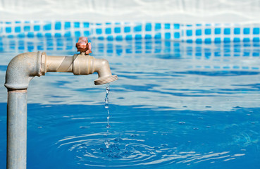 faucet dripping in a blue pool