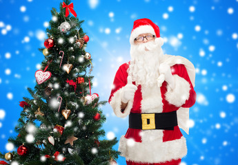 santa claus with bag and christmas tree
