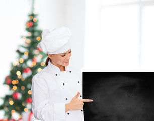 smiling female chef with white blank board