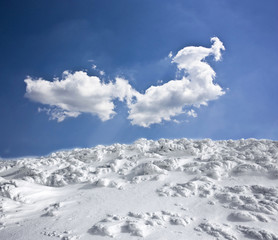 Naklejka na ściany i meble Winter landscape with snow covered hill and blue sky