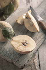 Ripe quinces on wooden table