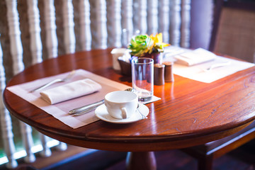 Served table for breakfast in luxury hotel with flowers