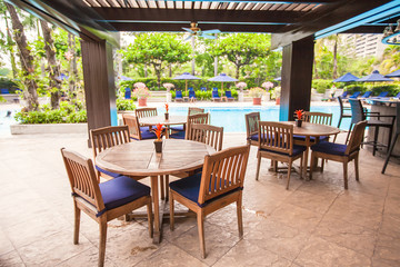 Summer empty open air cafe near swimming pool