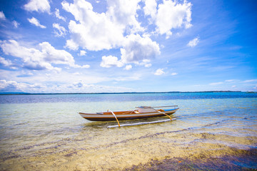 Small Fishing boat on white tropical beach