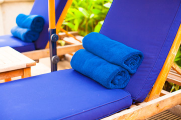 Close-up of towels near swimming pool at tropical resort
