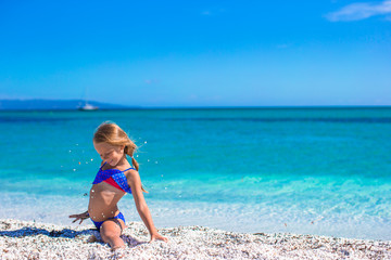 Little happy girl enjoying beach vacation