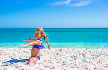 Adorable little sporty girl on white tropical beach