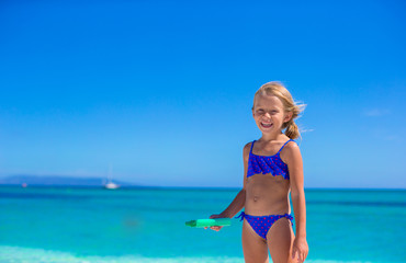 Adorable little girl have fun at tropical beach