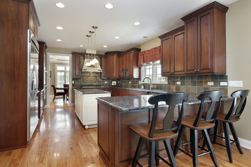 Kitchen with dark tile backsplash