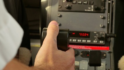 Pilot pushes throttle power control in cockpit with Tilt - Powered by Adobe
