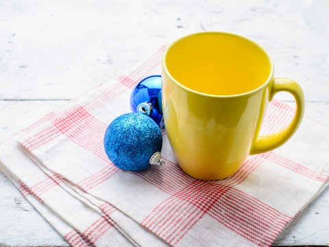 Yellow cup with christmas decoration.
