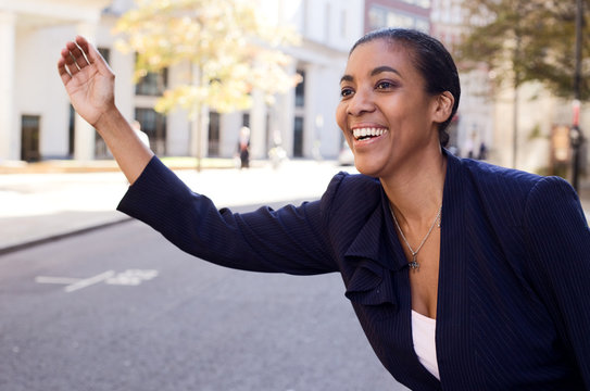 Business Woman Hailing A Taxi.