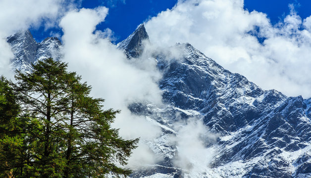 Snow covered mountains and rocky peaks in Himalaya